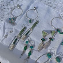 Load image into Gallery viewer, Silver and turquoise jewelry on a textured white surface
